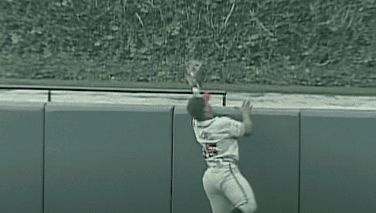 Andruw Jones making a spectacular catch, showcasing his defensive skills.